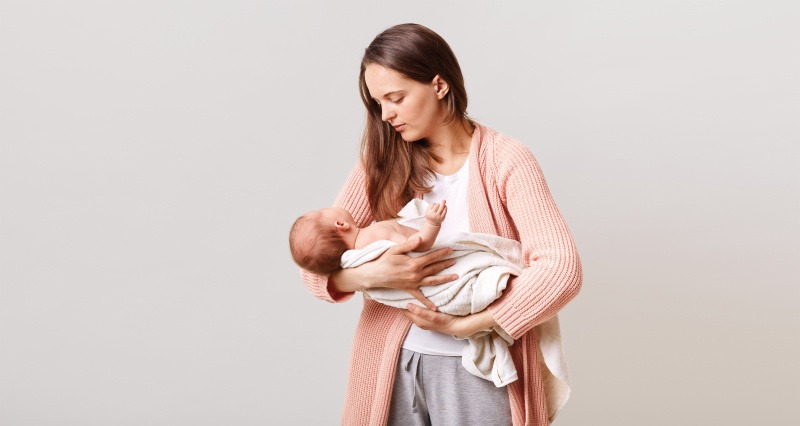 beautiful-dark-haired-mother-with-newborn-baby-in-hands