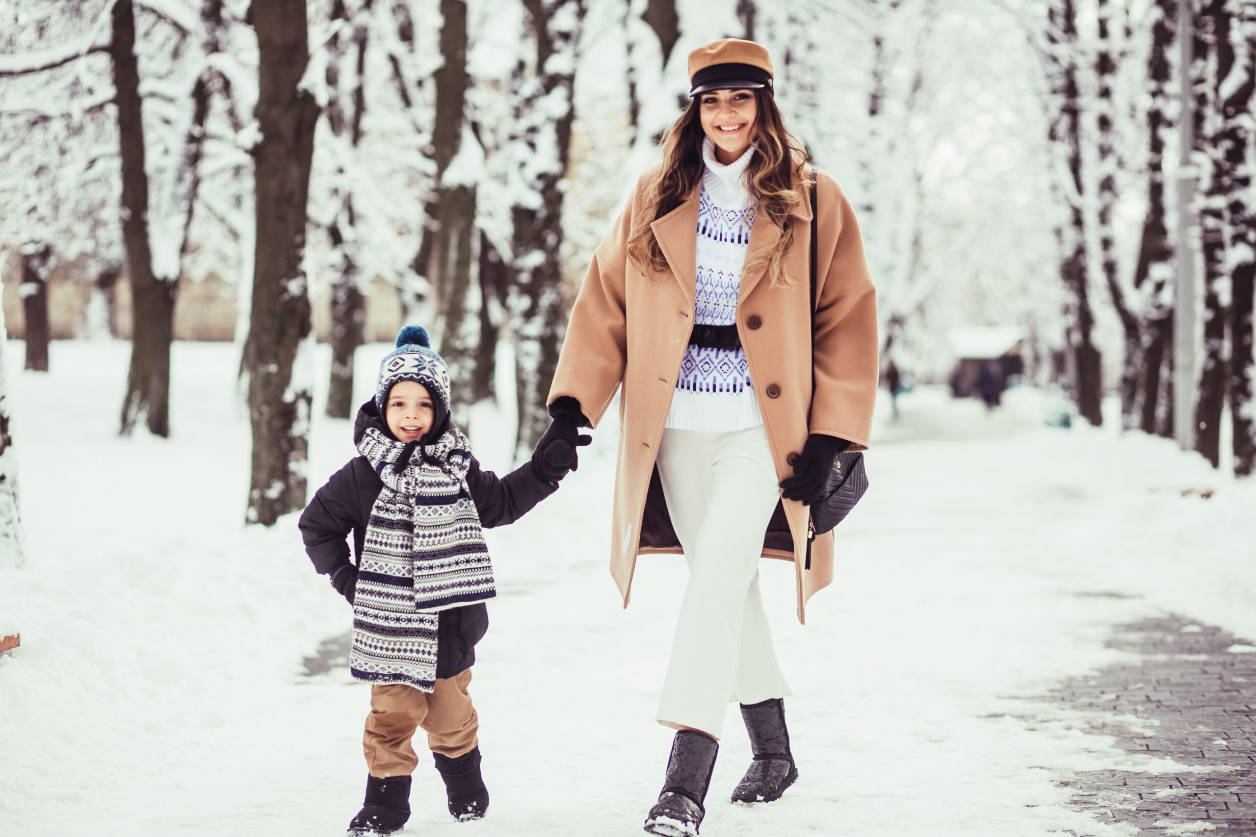 The mother with son walking along park